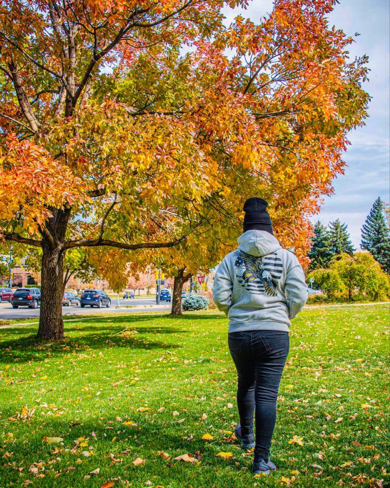 Hand printed American Eagle Hoodie Gray on female model in an autumn setting.