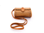 Natural rattan handbag hand woven in Bali Indonesia with leather strap and brass clasp.
