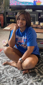 Shown on female model, blue PLU t-shirt showing Pinay Life in USA logo & two butterflies, hand printed in Philippines, in Philippines and American flag colors.