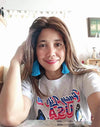Shown on female model, gray PLU t-shirt showing Pinay Life in USA logo & two butterflies, hand printed in Philippines, in Philippines and American flag colors.