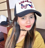 Pinay Life in USA logo cap in black & white, showing group logo along with two butterflies in Philippines & American flag colors on front white panel, displayed on female model.