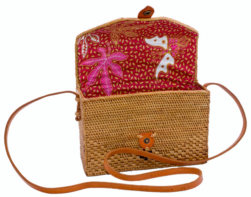 Roomy natural rattan handbag, rectangular shape, hand woven in Bali Indonesia with leather strap & brass clasp, showing colorful cotton lining.