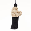 Handbag charm accessory, hand made in Philippines in shape of a small heart woven from natural rattan with a yarn tassel in black.