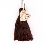 Handbag charm accessory, hand made in Philippines in shape of a small heart woven from natural rattan with a yarn tassel in dark chocolate color.