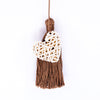 Handbag charm accessory, hand made in Philippines in shape of a small heart woven from natural rattan with a yarn tassel in milk chocolate color.