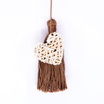 Handbag charm accessory, hand made in Philippines in shape of a small heart woven from natural rattan with a yarn tassel in milk chocolate color.