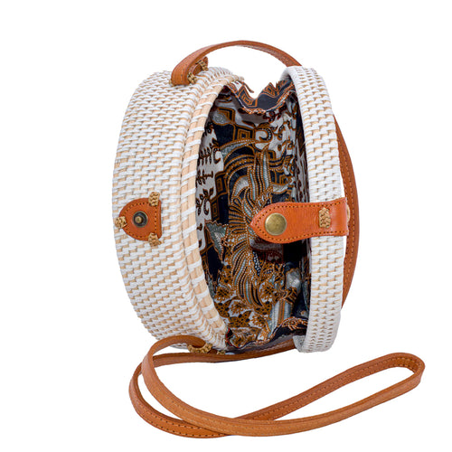 White rattan handbag hand woven in Bali Indonesia with hand painted insert featuring bird & flowers in many colors, with leather strap & brass clasp, showing colorful cotton lining.