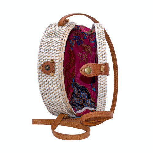 White rattan handbag hand woven in Bali Indonesia with hand painted insert in purple, blue, red & black, with leather strap & brass clasp, showing bright cotton lining.