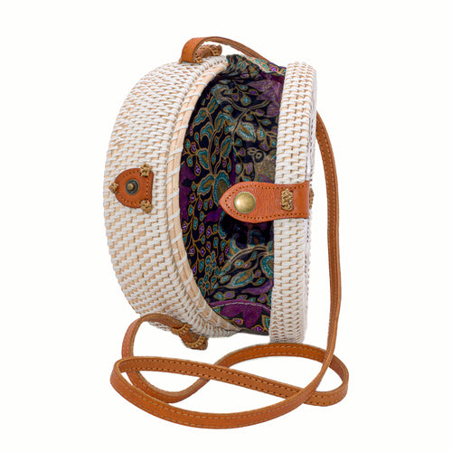 White rattan handbag hand woven in Bali Indonesia with hand painted insert showing bird & flower in red, yellow, blue & green, with leather strap & brass clasp, showing colorful cotton lining.