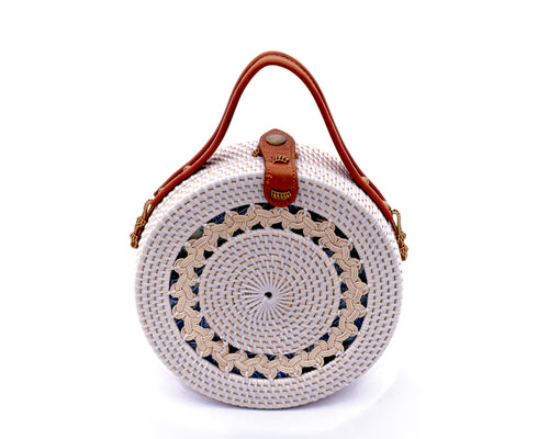 Round white rattan handbag hand woven in Bali showing tight rattan weaving, leather strap & brass clasp. Carry as handbag or shoulder bag by attaching removable strap.