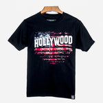Black T-shirt front side showing the Hollywood Sign imposed over an American Flag motif, hand printed in red, white & blue.