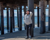 Cozy hoodie hand printed in Philippines, front view shown on female model posing on beach.